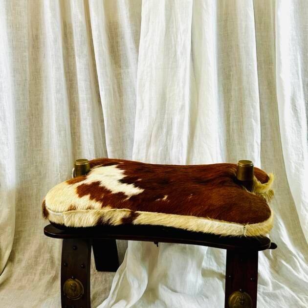 Vintage Moroccan camel saddle stool with cowhide upholstery 🐄.